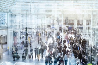 Commuters in modern train station